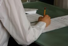 A student writing at a desk