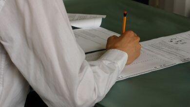 A student writing at a desk