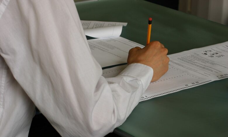 A student writing at a desk