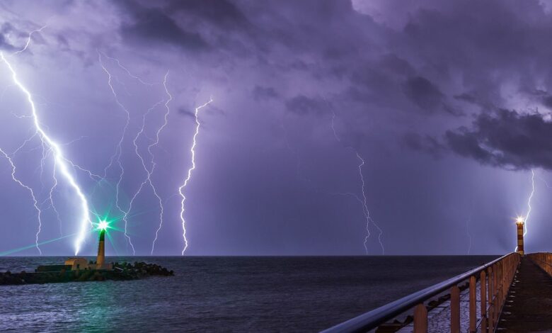 bright lightning strike beneath heavy storm clouds at night